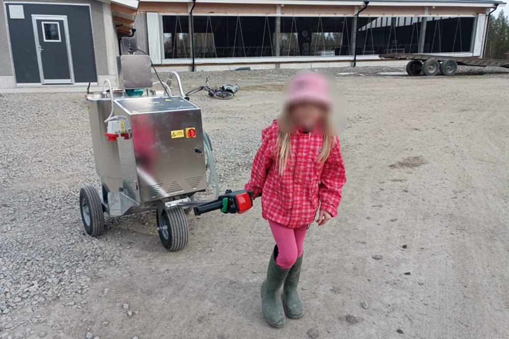 Little girl pulling a calf milk powder mixer